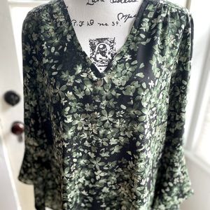 Women’s bell sleeve blouse by Belle.